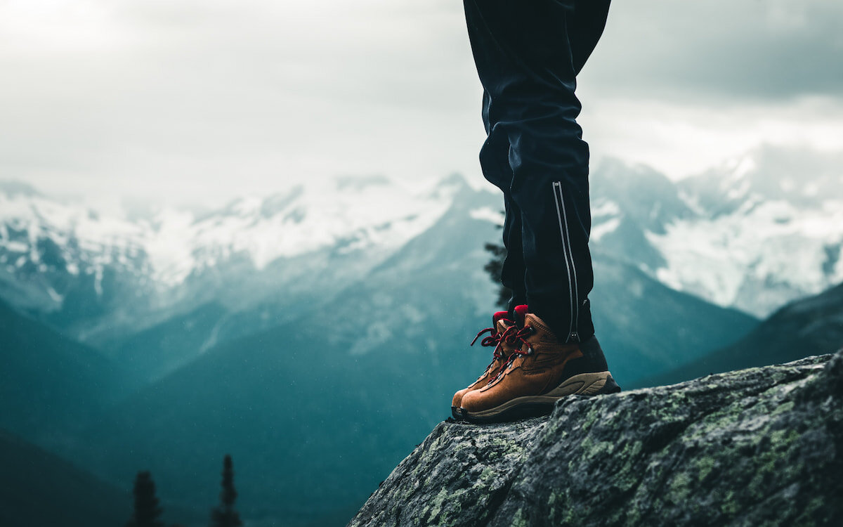 hiking boots with mountains in background